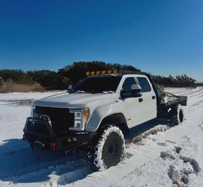White Ford F450 Flatbed Snowy Field